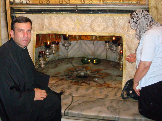 Father Samer and oum Fadi at the star in the Grotto of the Nativity (sy)