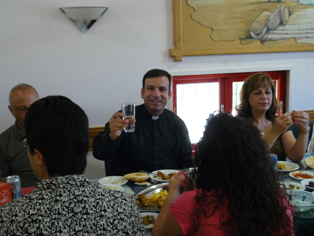 Fr Samer offers a toast at lunch, at Karwan "Abuzuz" Restaurant (rw)