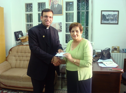 Father Samer giving our donation to the Annahda Women's Association (sy)