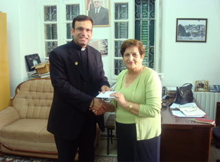 Father Samer giving our donation to the Annahda Women's Association (sy)