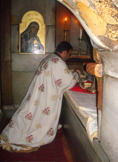 Father Samer preparing the Host for the Liturgy in the Holy Sepulchre (sy)