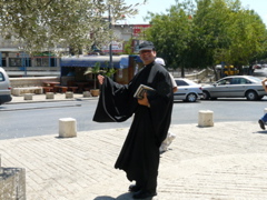 Father Samer in the wind near Mary's well, Nazareth