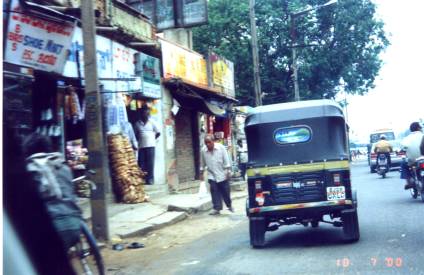Street scene with Auto-Rickshaw and man walking
