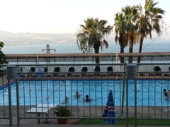 The wonderful swimming pool at the Golan Hotel Tiberias, with the Sea of Galilee and the Golan Heights beyond (rw)